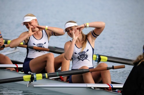 Two girls in their boat making hearts with their hands
