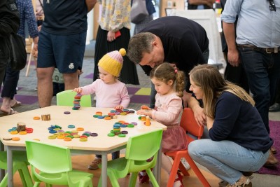 Children playing with their parents at the 2022 Art Exhibition.